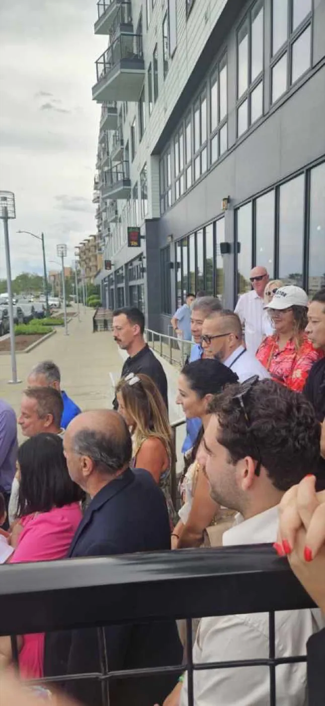 People gathered outside a Revere business.